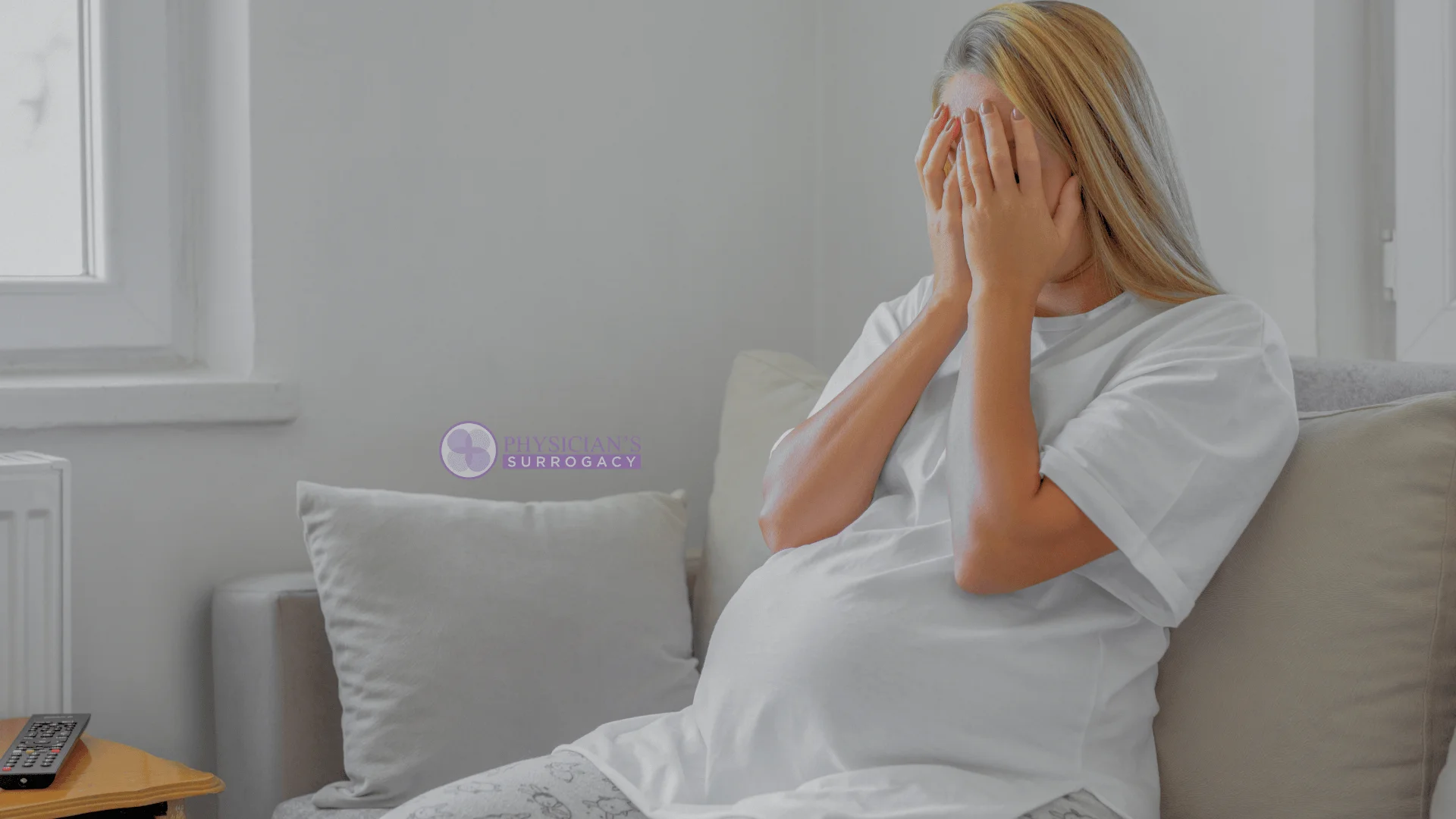 physicians-surrogacy-stressed-surrogate-covering-face-while-sitting-at-home